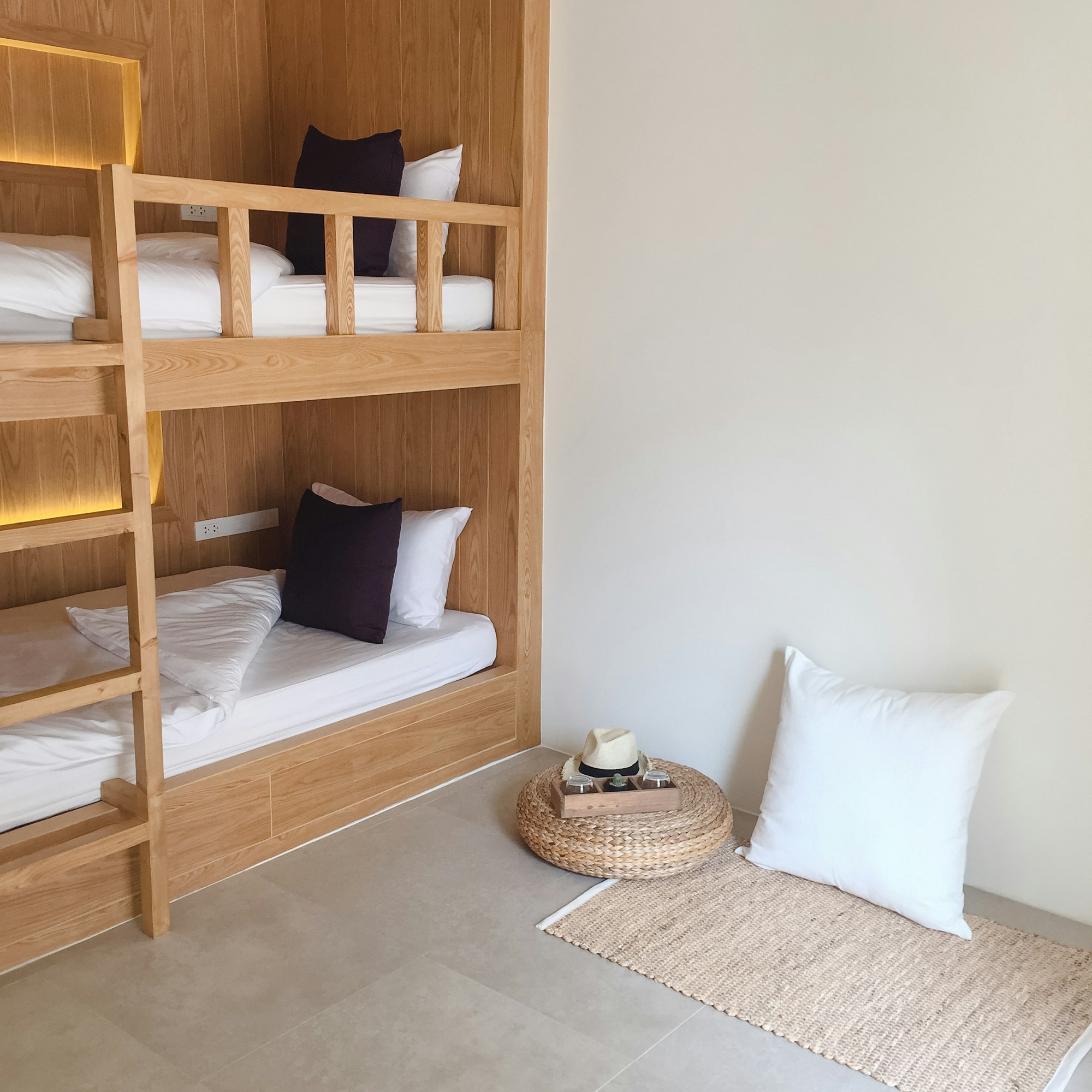 Clean hostel room with wooden bunk beds.